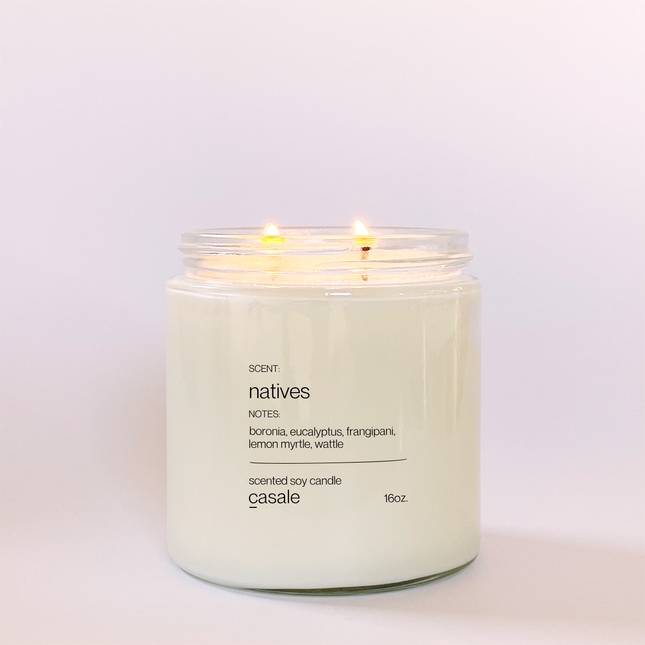 NATIVES DOUBLE WICKED SOY CANDLE (16oz / 453g) lit with calming sensory lighting, helping families thrive with tools to calm, connect and support