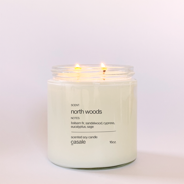 Lit NORTH WOODS DOUBLE WICKED SOY CANDLE (16oz / 453g) with warm natural lighting to calm and support families