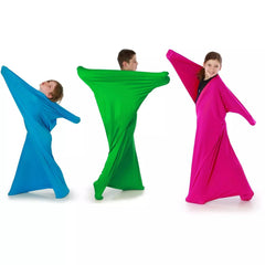 Three children playing and stretching colorful Lycra Body Socks in blue, green, and pink sensory suits.