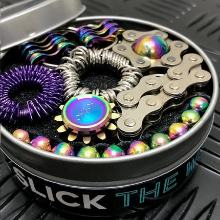 The Works Fidget Kit in a metal tin with colorful metallic and silver sensory fidget tools arranged inside